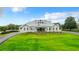 Beautiful exterior of building with well-manicured lawn, circular driveway and architectural design at 10181 Holly Berry Dr, Weeki Wachee, FL 34613