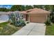 Inviting single-Gathering home featuring a lush front yard and attached two-car garage at 10181 Holly Berry Dr, Weeki Wachee, FL 34613