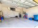 Clean two-car garage with white walls, storage, and access door at 10181 Holly Berry Dr, Weeki Wachee, FL 34613