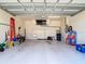Spacious two-car garage featuring white walls and an epoxy floor at 10181 Holly Berry Dr, Weeki Wachee, FL 34613