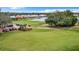 Scenic golf course view showcasing lush greens, golf carts, and nearby residential area by the water at 10181 Holly Berry Dr, Weeki Wachee, FL 34613