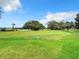 Well-maintained golf course featuring lush green grass, mature trees, and blue skies at 10181 Holly Berry Dr, Weeki Wachee, FL 34613