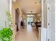 Inviting hallway with tile floors leading to living spaces and featuring decorative columns at 10181 Holly Berry Dr, Weeki Wachee, FL 34613