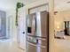 Spacious kitchen with stainless steel refrigerator and adjacent doorway leading to living area at 10181 Holly Berry Dr, Weeki Wachee, FL 34613