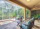 Screened lanai with a hot tub, ceiling fan, outdoor furniture, and lush greenery at 10181 Holly Berry Dr, Weeki Wachee, FL 34613