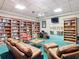 Inviting library space with multiple bookshelves, cozy seating, and a view of the library at 10181 Holly Berry Dr, Weeki Wachee, FL 34613
