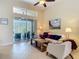 Cozy living room with a plush white sofa and access to the outdoor patio area at 10181 Holly Berry Dr, Weeki Wachee, FL 34613