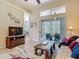 Bright living room with tile floors, large windows, sliders to lanai, and comfortable seating for entertaining at 10181 Holly Berry Dr, Weeki Wachee, FL 34613
