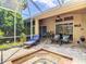 Relaxing screened-in patio featuring a spa and comfortable seating, perfect for enjoying the outdoors at 10181 Holly Berry Dr, Weeki Wachee, FL 34613