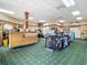 Retail area with golf accessories, clothing, and a sales counter, all with a plaid carpet at 10181 Holly Berry Dr, Weeki Wachee, FL 34613