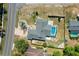 Aerial view of a home with a screened-in pool and manicured landscaping at 10267 Elgin Blvd, Spring Hill, FL 34608
