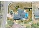 Aerial view shows the layout of a home featuring a screened-in pool and hardscaped areas at 10267 Elgin Blvd, Spring Hill, FL 34608