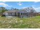Backyard view of the pool and the house, showcasing the outdoor area and potential for recreation at 10267 Elgin Blvd, Spring Hill, FL 34608