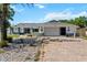 Inviting home exterior featuring a brick driveway, attached garage and manicured landscaping at 10267 Elgin Blvd, Spring Hill, FL 34608