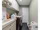 Practical laundry room with washer, dryer, sink, and storage cabinets at 10267 Elgin Blvd, Spring Hill, FL 34608