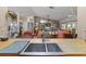 Open living room with high ceilings, a ceiling fan, and a view from the kitchen sink at 10267 Elgin Blvd, Spring Hill, FL 34608