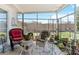 Relaxing screened patio featuring wicker furniture, providing a comfortable outdoor seating area at 10267 Elgin Blvd, Spring Hill, FL 34608