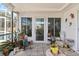 Charming patio area with plants and an entrance door, creating a cozy outdoor living space at 10267 Elgin Blvd, Spring Hill, FL 34608