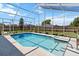 Sparkling pool with a screened enclosure, offering a refreshing escape and a view of the fenced backyard at 10267 Elgin Blvd, Spring Hill, FL 34608