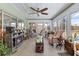 Bright sunroom with a fireplace, ceiling fan, tile floor, and abundant natural light, perfect for relaxing at 10267 Elgin Blvd, Spring Hill, FL 34608