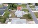 An aerial view of a home showcasing a well-maintained backyard, white fence, and proximity to neighborhood streets at 10386 Myra St, Spring Hill, FL 34608