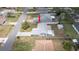 Aerial view of a single-Gathering home featuring a long driveway and mature landscaping in a residential neighborhood at 10386 Myra St, Spring Hill, FL 34608