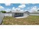 Fenced backyard with a covered patio, offering privacy and space for outdoor activities at 10386 Myra St, Spring Hill, FL 34608