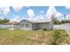 Home's backyard featuring a well-kept lawn and a white privacy fence at 10386 Myra St, Spring Hill, FL 34608