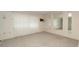 Bright living room with neutral walls, mirrored accents, and large windows at 10386 Myra St, Spring Hill, FL 34608