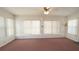 Bright living room filled with natural light, plush carpet, and spacious layout at 10386 Myra St, Spring Hill, FL 34608