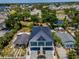 An aerial shot showcasing the two-story home nestled among lush greenery, with nearby lake and streets at 111 E Cedar St, Tarpon Springs, FL 34689
