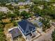 An aerial perspective of a modern two-story home with a dark roof, nestled within a vibrant residential area at 111 E Cedar St, Tarpon Springs, FL 34689
