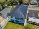 Aerial view of a renovated two-story home with modern metal roof and fenced yard at 111 E Cedar St, Tarpon Springs, FL 34689