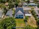Aerial view of a renovated two-story home with a well-manicured lawn and a modern metal roof at 111 E Cedar St, Tarpon Springs, FL 34689
