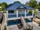 A high angle shot reveals this two-story home's metal roof, staircases and spacious ground floor parking at 111 E Cedar St, Tarpon Springs, FL 34689
