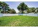 Spacious backyard featuring lush green grass, enclosed with a white vinyl fence, providing privacy at 111 E Cedar St, Tarpon Springs, FL 34689