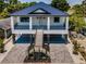 Beautiful two-story home with a metal roof, inviting porch and well-designed landscaping at 111 E Cedar St, Tarpon Springs, FL 34689