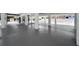 Elevated open garage featuring concrete flooring, sleek support columns, and ample space at 111 E Cedar St, Tarpon Springs, FL 34689