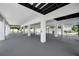 Spacious open garage with black ceiling beams and a clean, modern look at 111 E Cedar St, Tarpon Springs, FL 34689