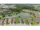 Aerial view of a community with lake, tennis courts, playground, and beautiful homes at 11398 Juglans Dr, Odessa, FL 33556