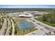 Sprawling community school featuring tennis courts, parking, and ample green space surrounded by trees and athletic fields at 11398 Juglans Dr, Odessa, FL 33556