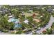 Aerial view of the neighborhood's community park with pool, playground, and open green space for residents at 11398 Juglans Dr, Odessa, FL 33556