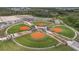 Aerial view of baseball fields with well-maintained green grass and orange clay at 11398 Juglans Dr, Odessa, FL 33556