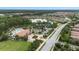 Expansive aerial view of community amenities with pool, clubhouse, lake, and lush landscaping in a desirable neighborhood at 11398 Juglans Dr, Odessa, FL 33556