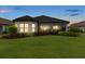 Elegant rear facade with well-manicured lawn and landscaping, creating curb appeal at 11398 Juglans Dr, Odessa, FL 33556