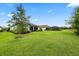 Expansive backyard with lush lawn and view of multiple screened-in lanais, perfect for outdoor living at 11398 Juglans Dr, Odessa, FL 33556
