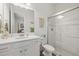 Modern bathroom with white vanity, decorative hanging, and a glass-enclosed shower at 11398 Juglans Dr, Odessa, FL 33556