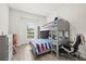 bedroom with bunk beds, gray desk, and bright window at 11398 Juglans Dr, Odessa, FL 33556