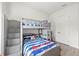 Bright bedroom with a gray bunk bed and colorful striped bedding, complemented by ample natural light at 11398 Juglans Dr, Odessa, FL 33556