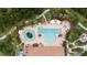 Aerial view of community pool with lounge chairs, umbrellas, and lush landscaping creating a resort-style atmosphere at 11398 Juglans Dr, Odessa, FL 33556